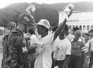 An American soldier frisks a Panamanian man